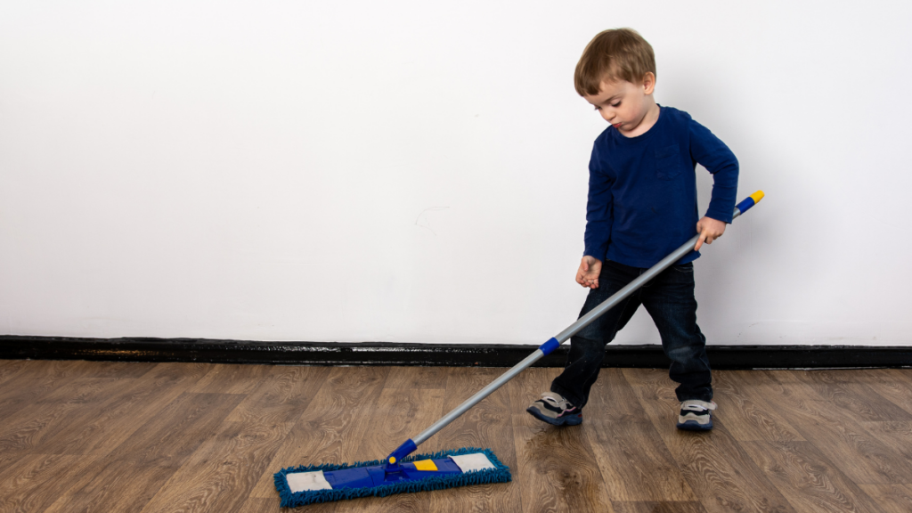 kid sweeping floor