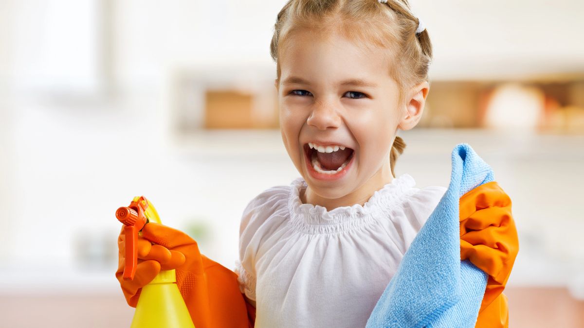 little girl with cleaning supplies