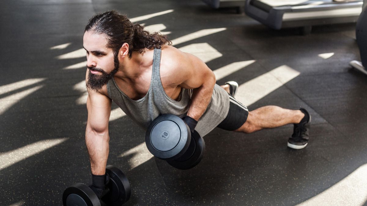 man doing a plank with weight