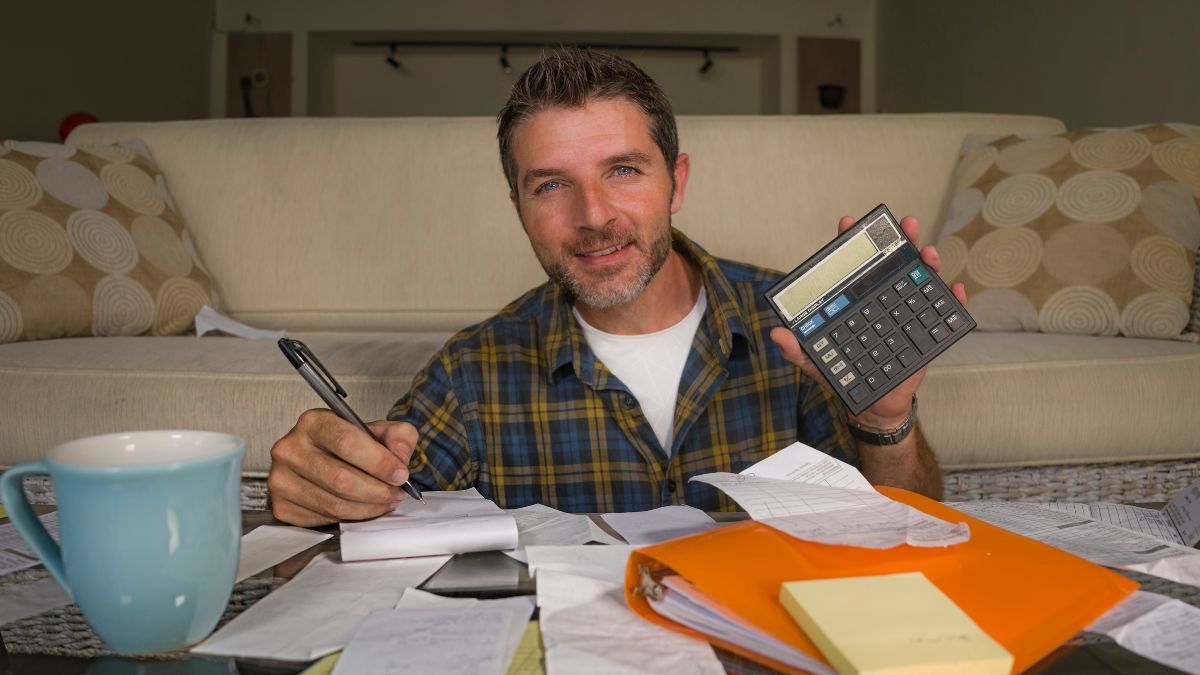 man doing bills with calculator