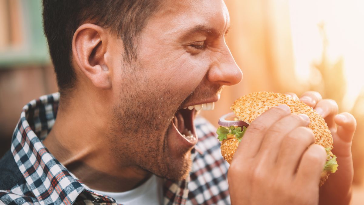 man eating burger