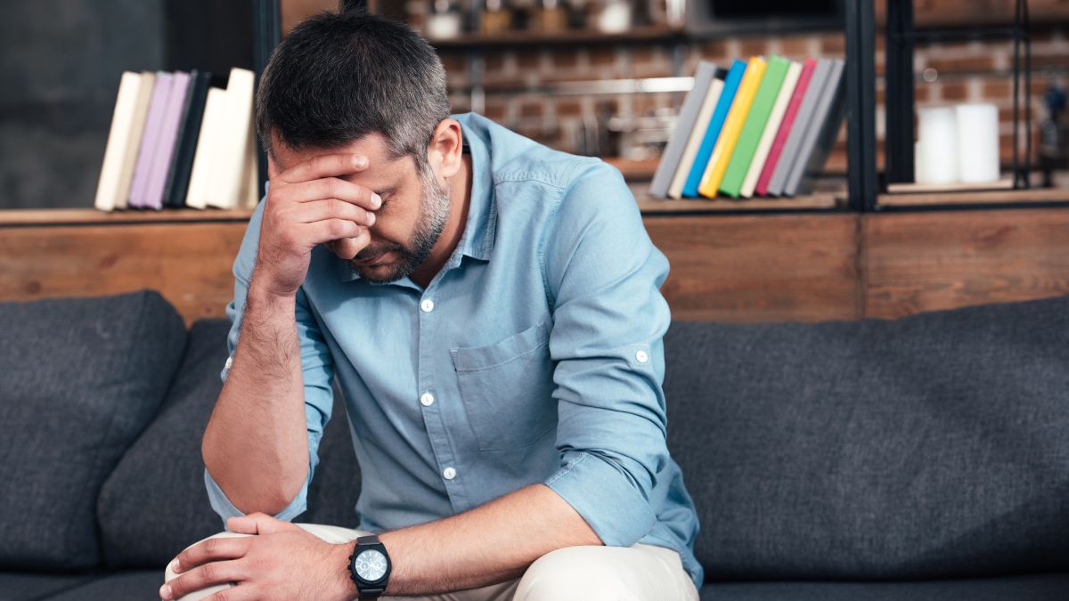 man frustrated on the couch