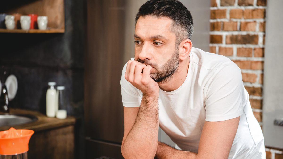 man looking bummed at the kitchen counter