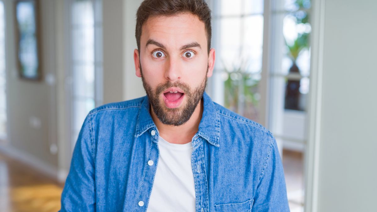 man looking shocked on couch