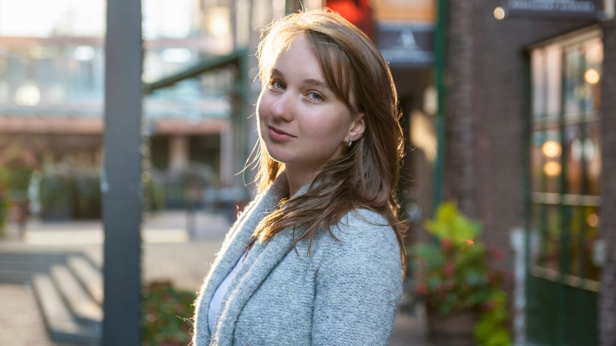 millennial woman standing outside smiling