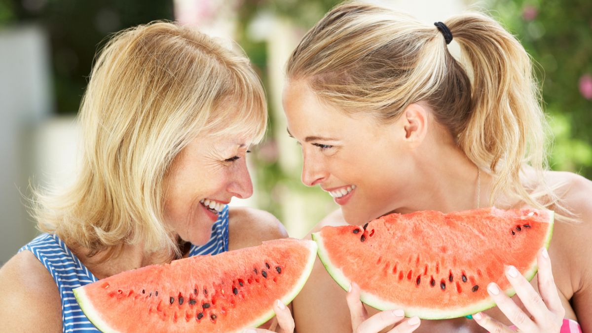 mother and daughter smiling with watermelon