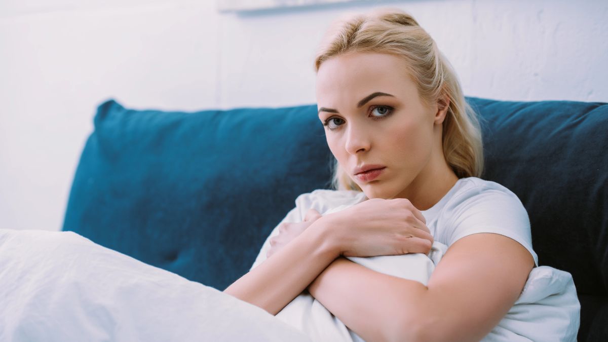 stressed woman hugging a pillow