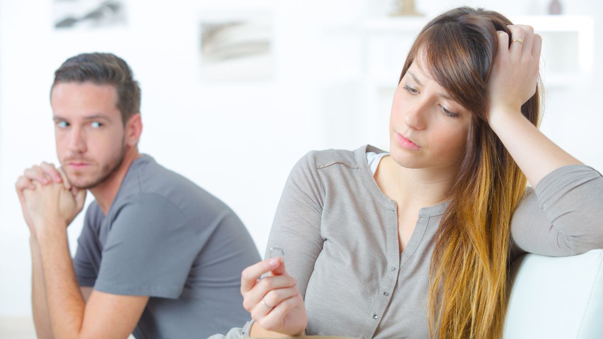 upset couple woman looking at ring