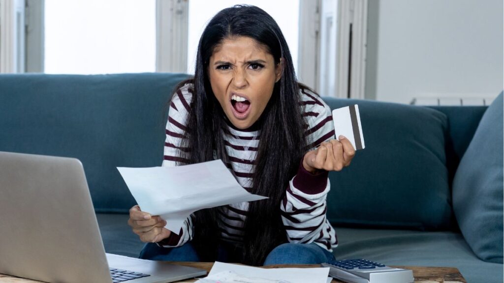 woman confused with bills and credit card