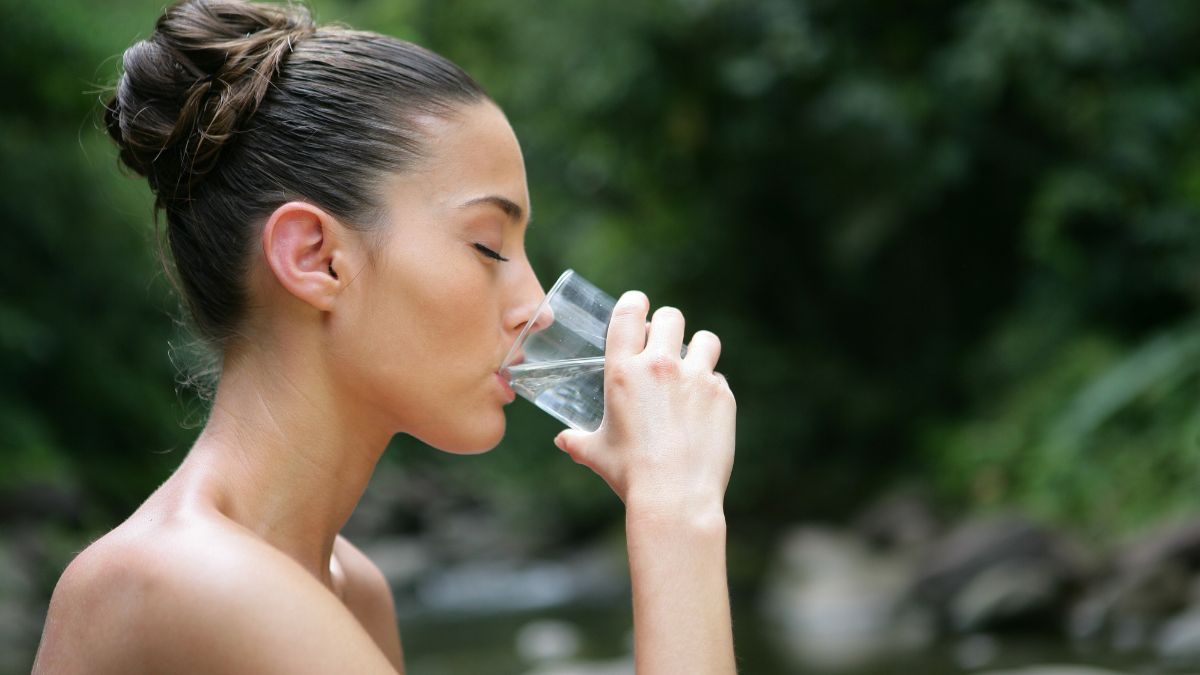 woman drinking water outside