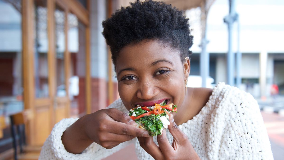 woman eating veggie pizza