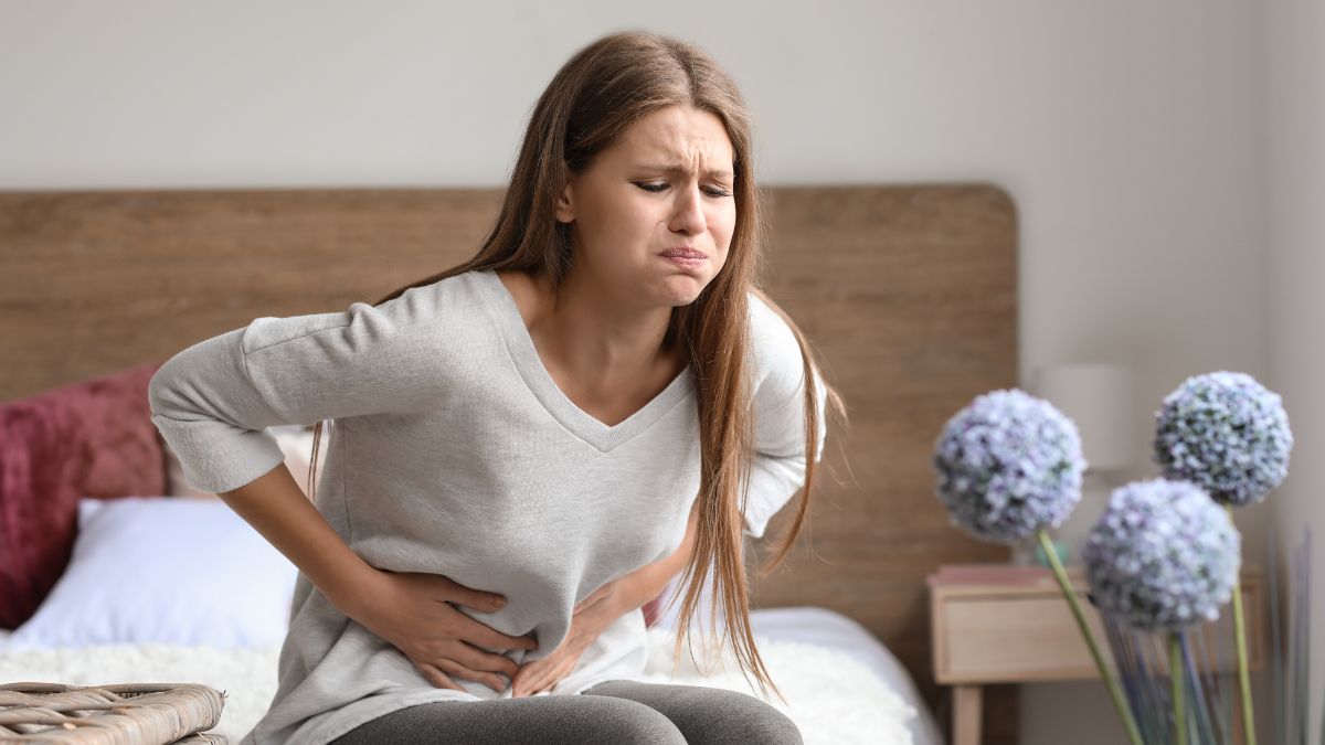 woman holding a glass of milk with an upset stomach