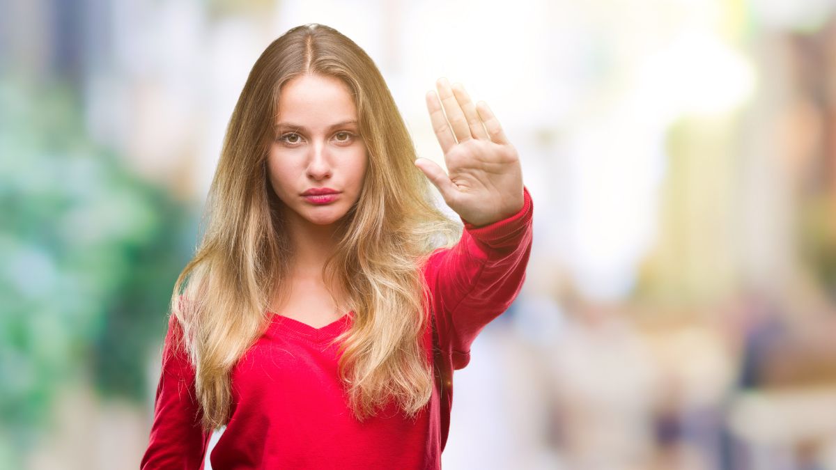 woman in red with hand up showing stop.jpg