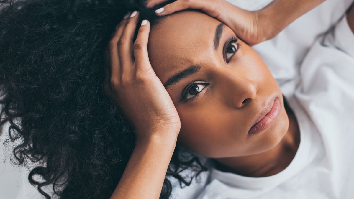 woman looking frustrated with hands on head