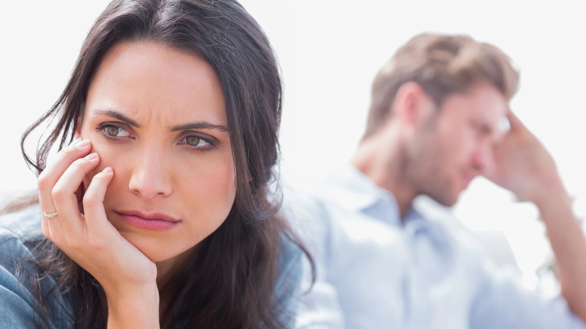 woman looking irritated away from man