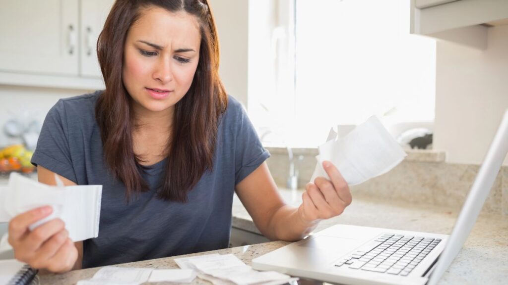 woman looking stressed with bills