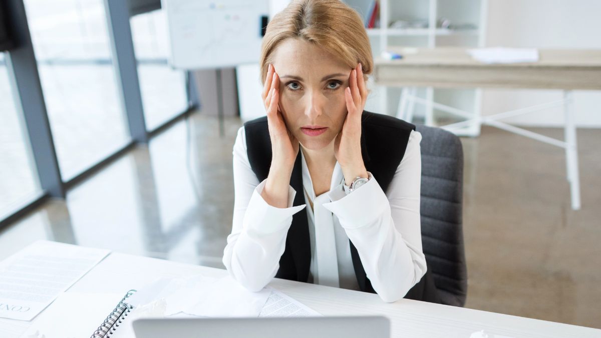 woman looking stressed with hands on head