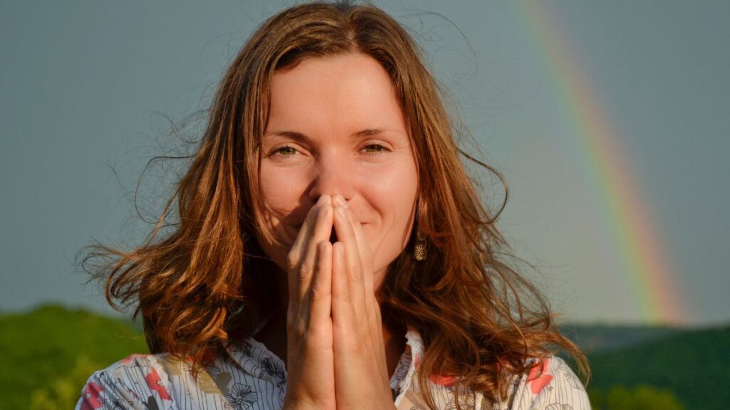 woman looking thankful with hand by mouth