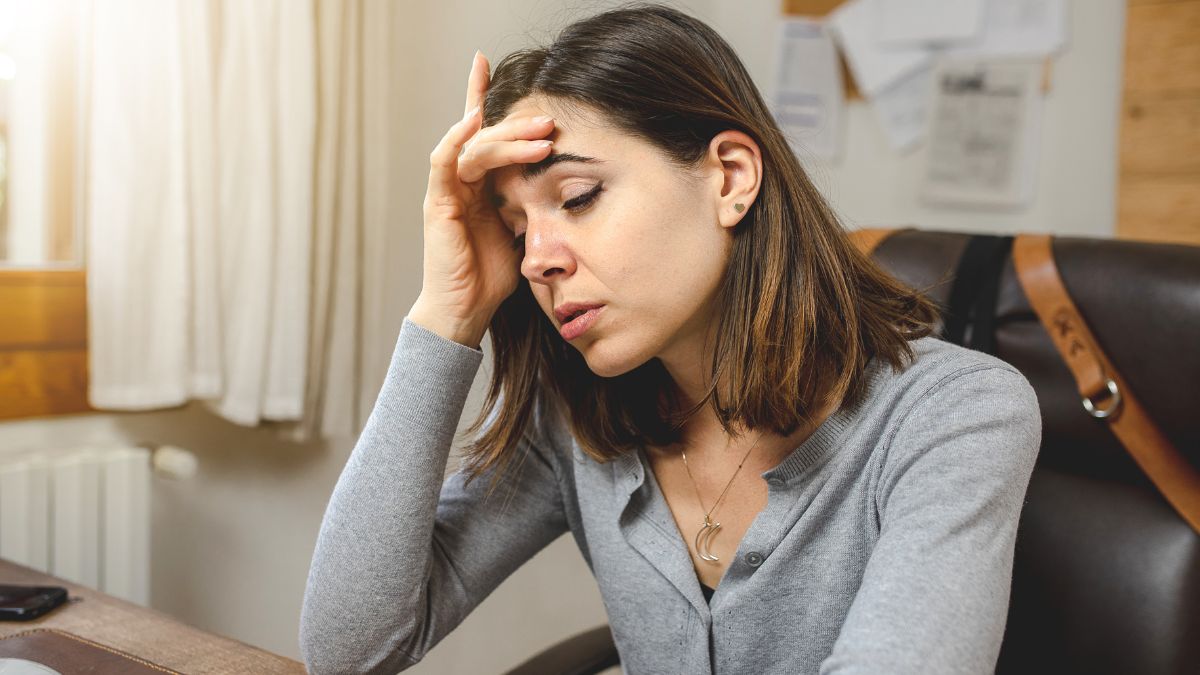 woman sitting at a desk looking frustrated