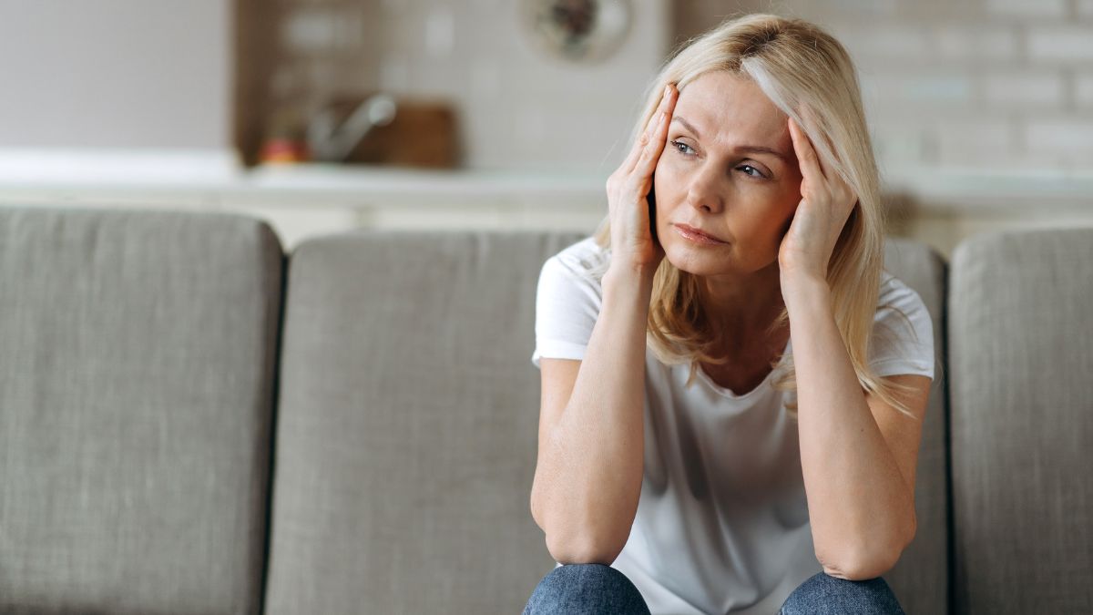 woman sitting on couch looking irritated