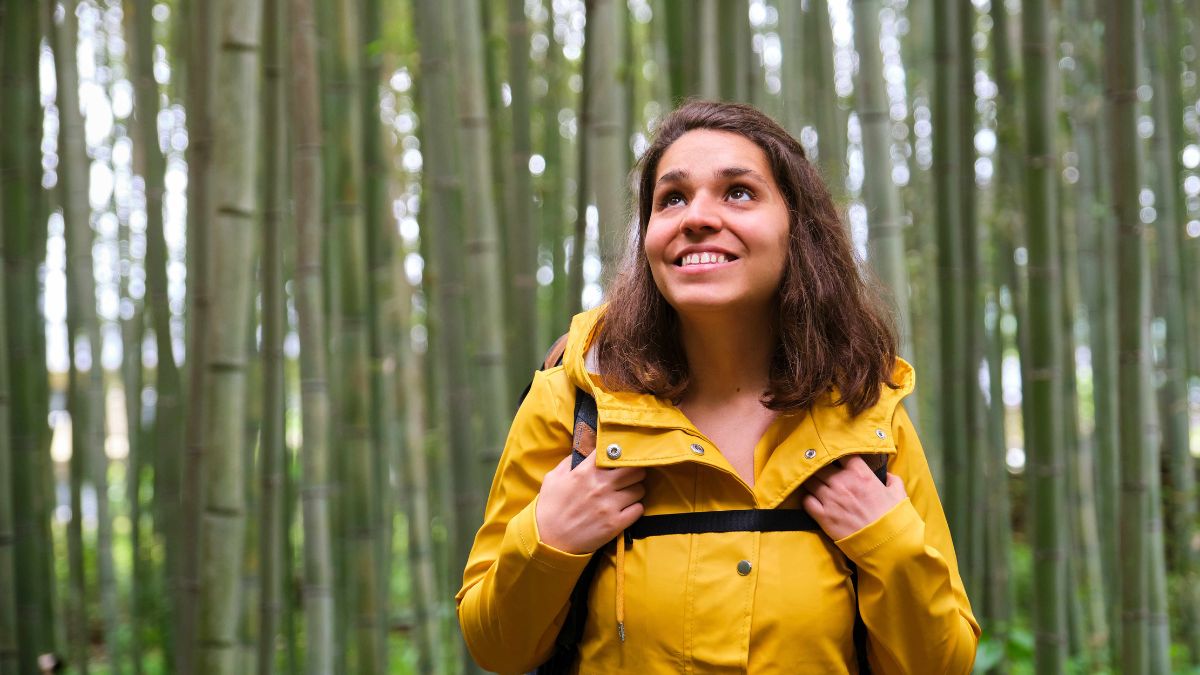 woman smiling in the woods alone