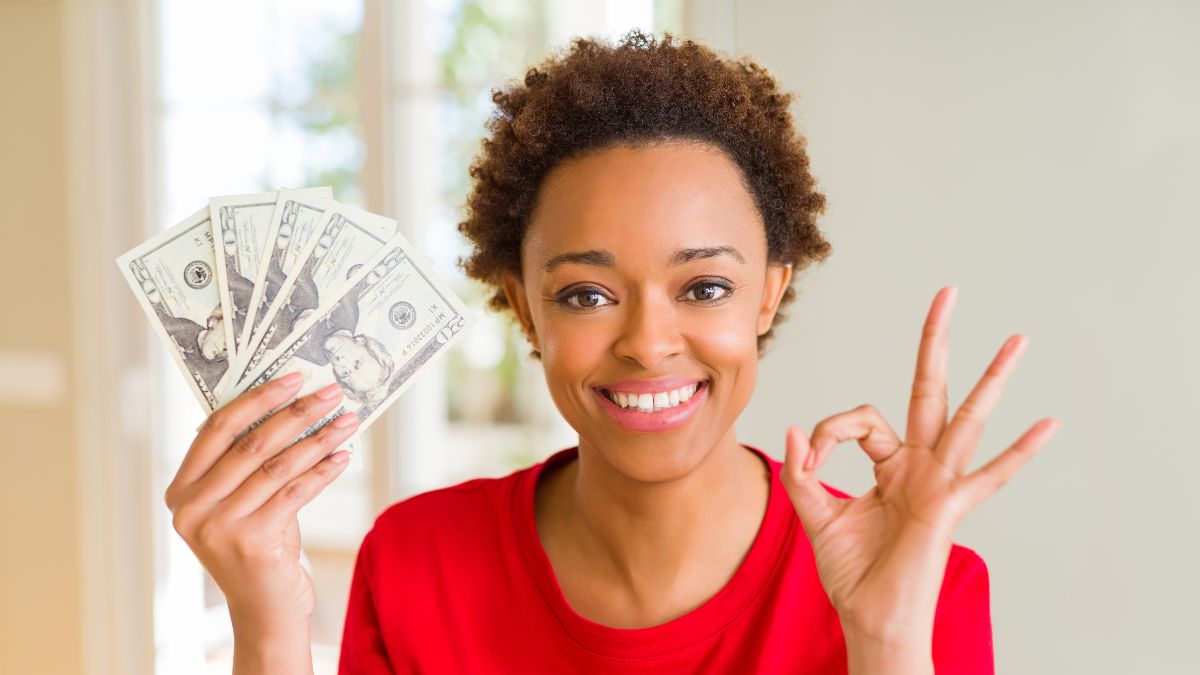 woman smiling with money