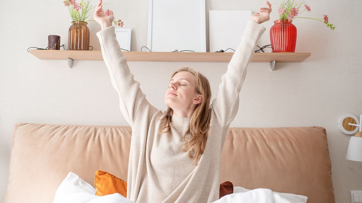 woman stretching in bed