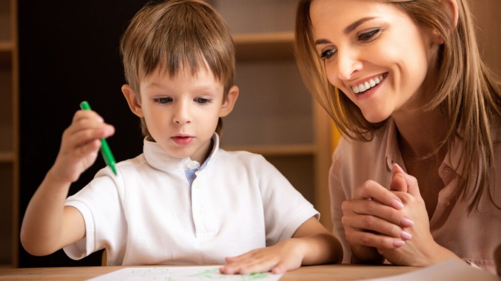 woman tutoring boy