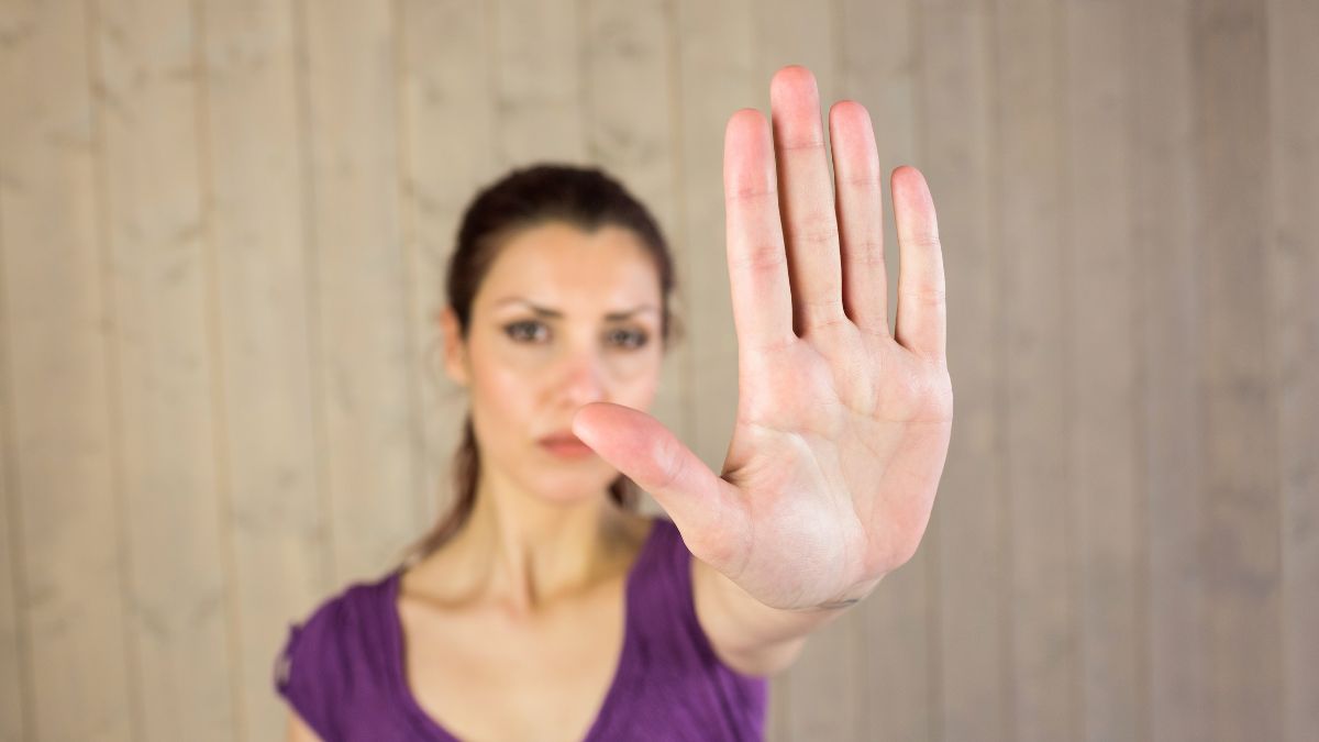 woman with hand up showing stop