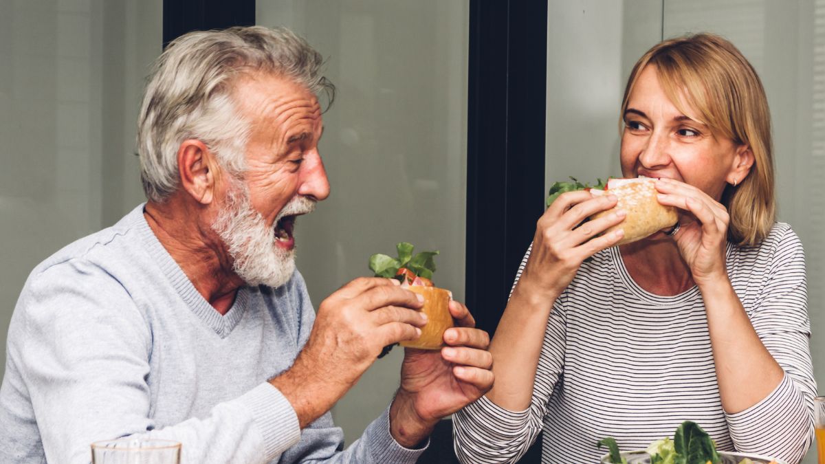 Retired couple eating healthy sandwiches