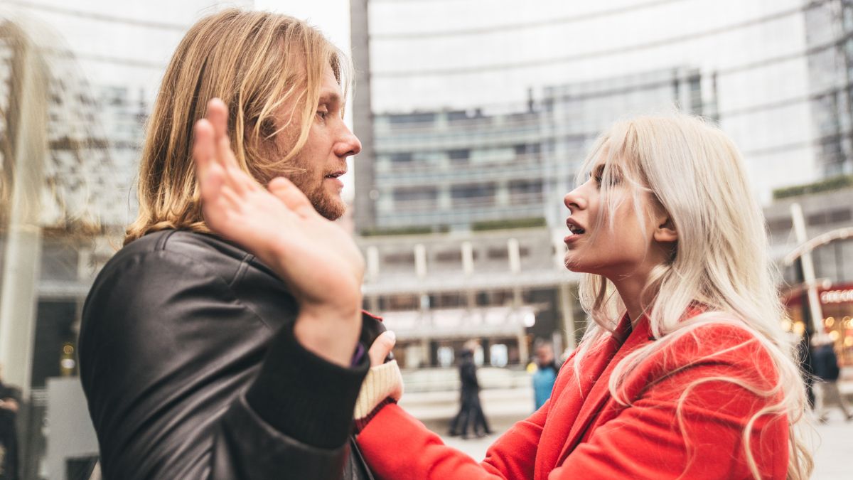 couple fighting woman grabbing man