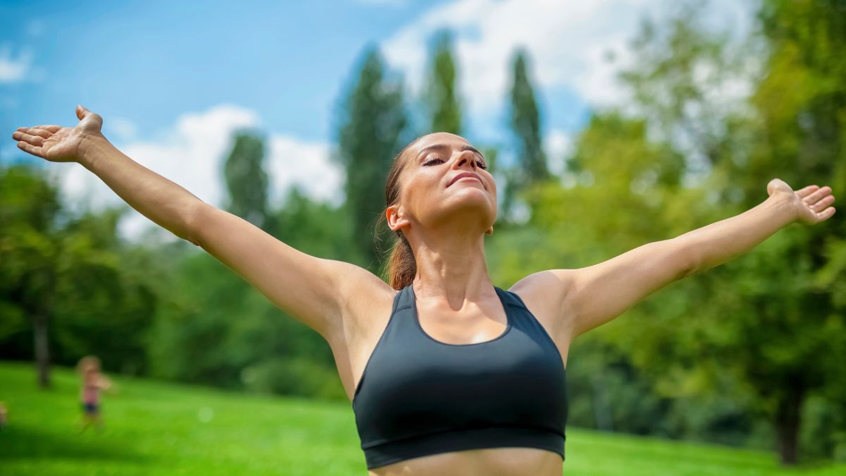 energetic woman with hands up