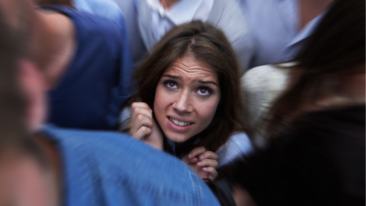 woman looking overwhelmed in a crowd