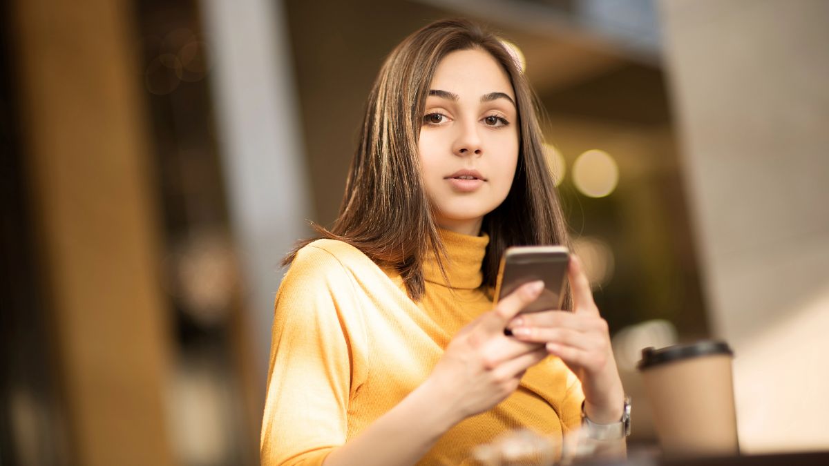 woman looking up from her phone