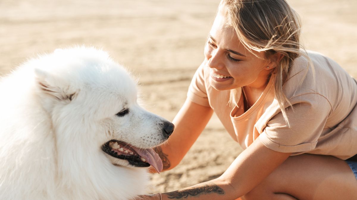 woman petting big white dog