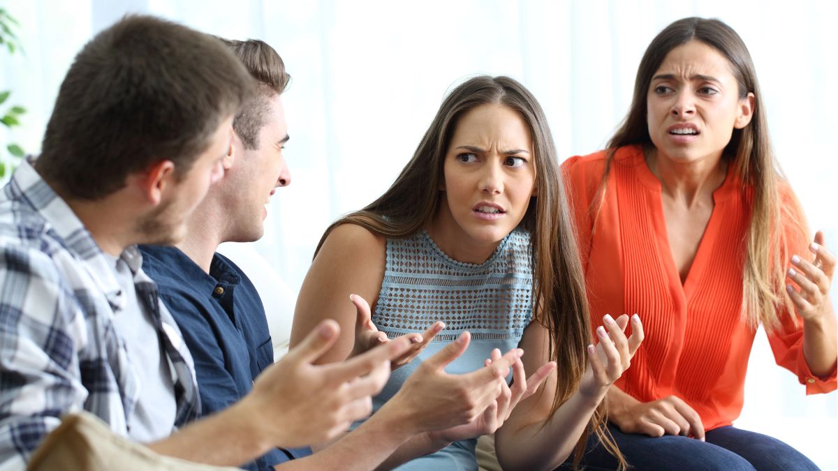 women looking offended in conversation with men