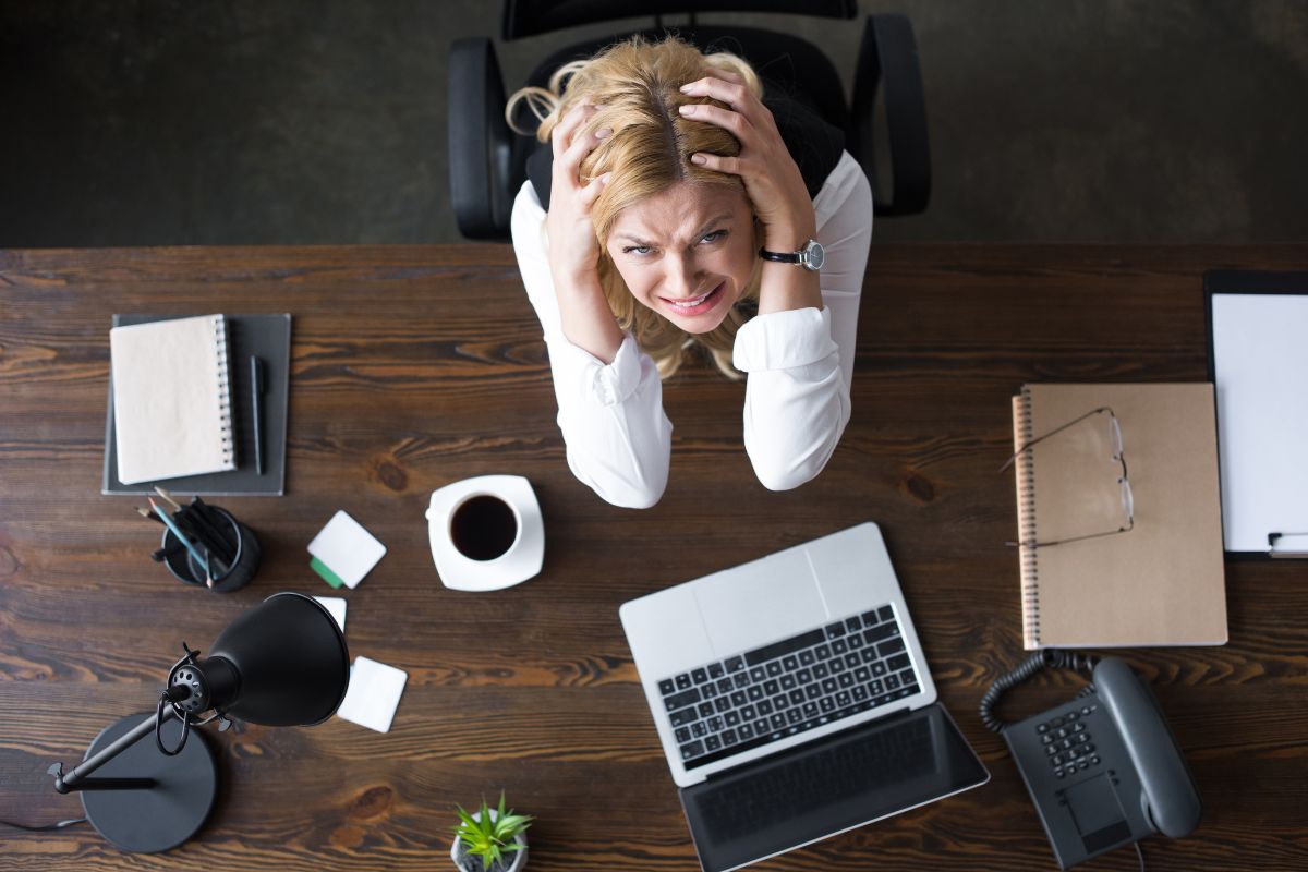 Woman looking up from her laptop frustrated.